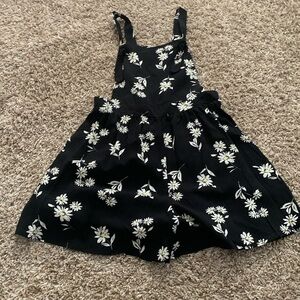 The brand is target size is medium 7-8 colors are black with white daisys.